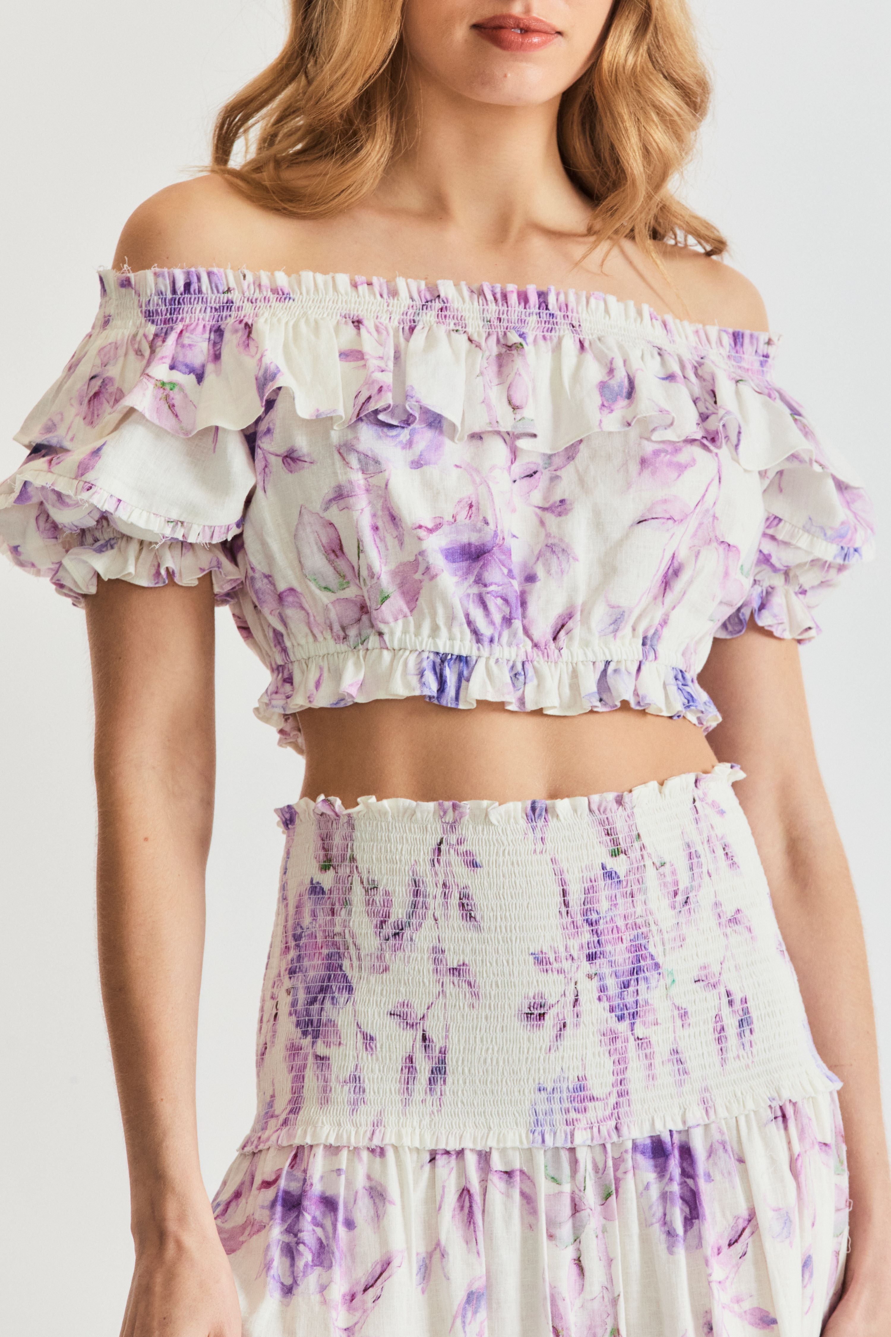 LoveShackFancy Audrille crop top. Off the shoulder ruffle crop top in white with purple floral print.