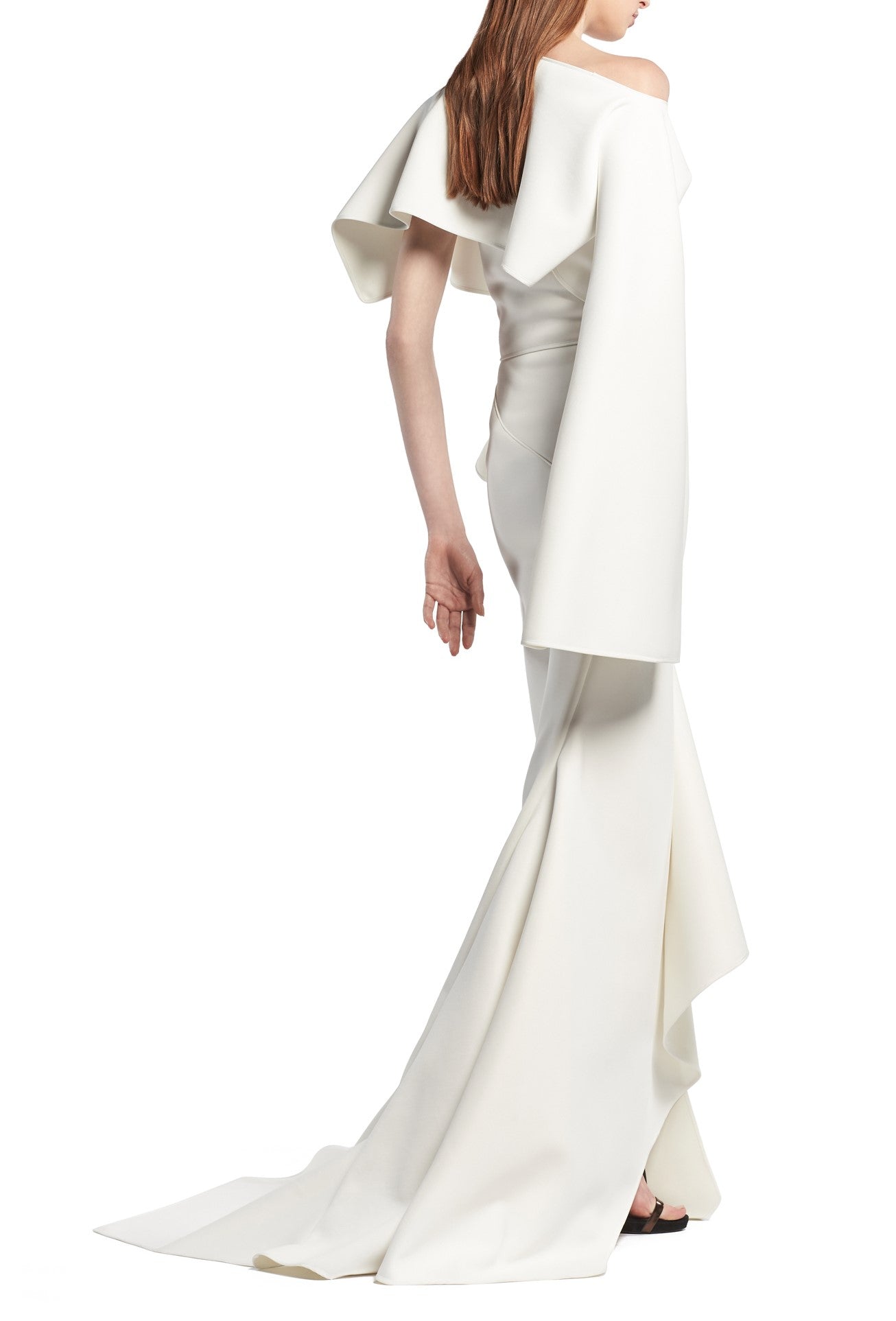 Toni Maticevski Arrival gown. Boat neckline gown with one flutter half sleeve and one long sleeve. Features a ruffle thigh high slit.
