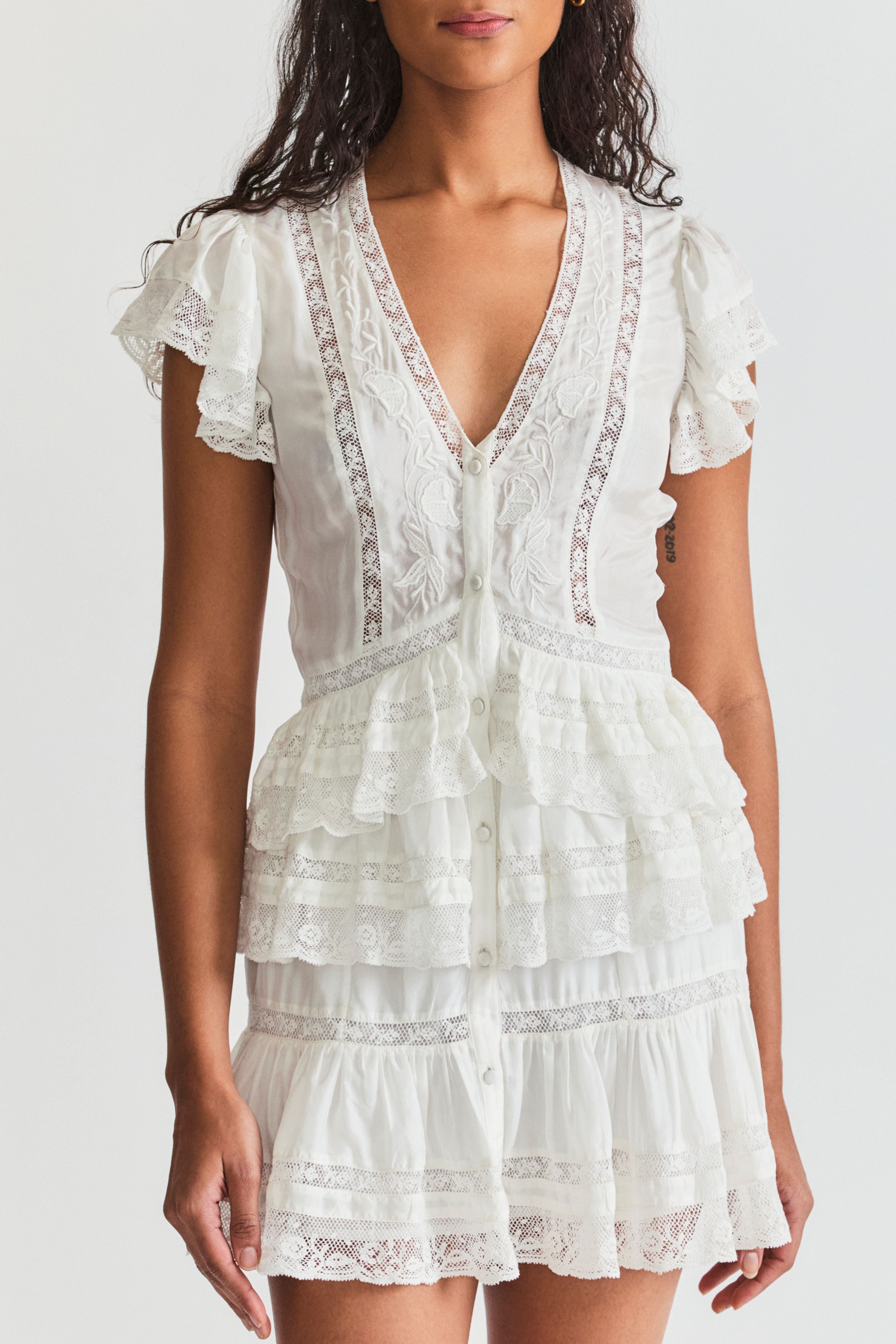 LoveShackFancy Kindler dress. Short sleeve v-neck summer short dress with flutter cap sleeves and lace detailing.