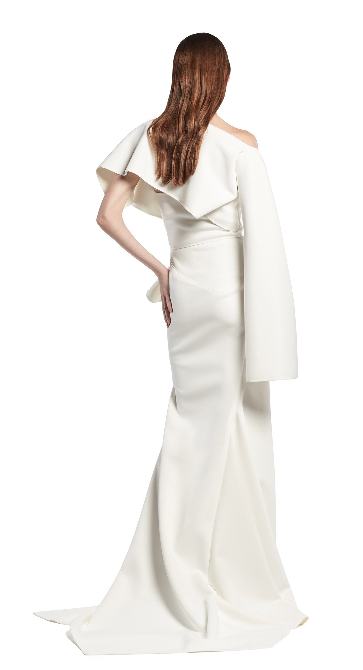 Toni Maticevski Arrival gown. Boat neckline gown with one flutter half sleeve and one long sleeve. Features a ruffle thigh high slit.